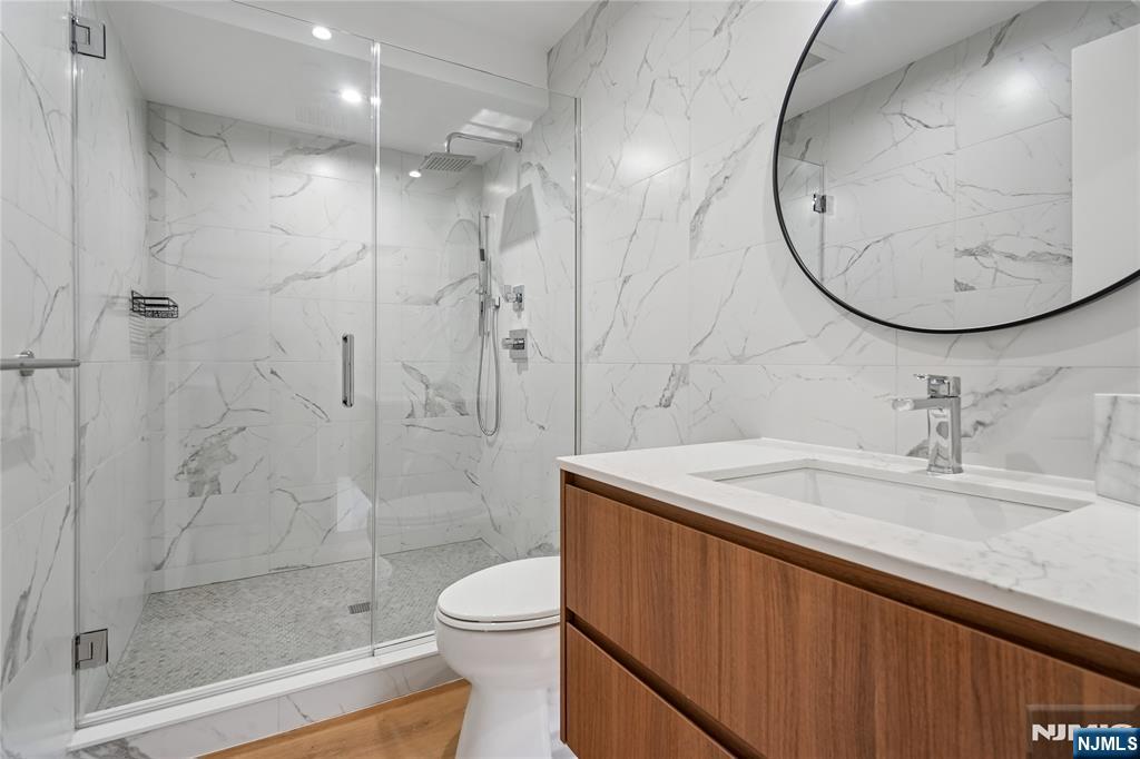 426 Aurora Avenue Cliffside Park, NJ 07010 - Photo 23 of 38 a bathroom with a sink a toilet and a mirror