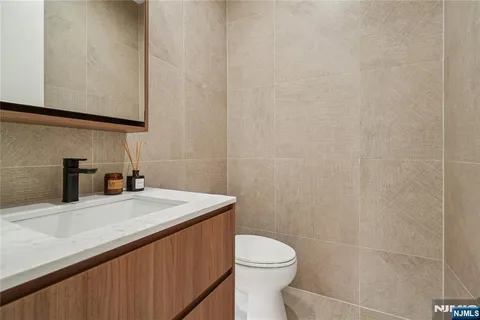 a bathroom with a sink a toilet and mirror