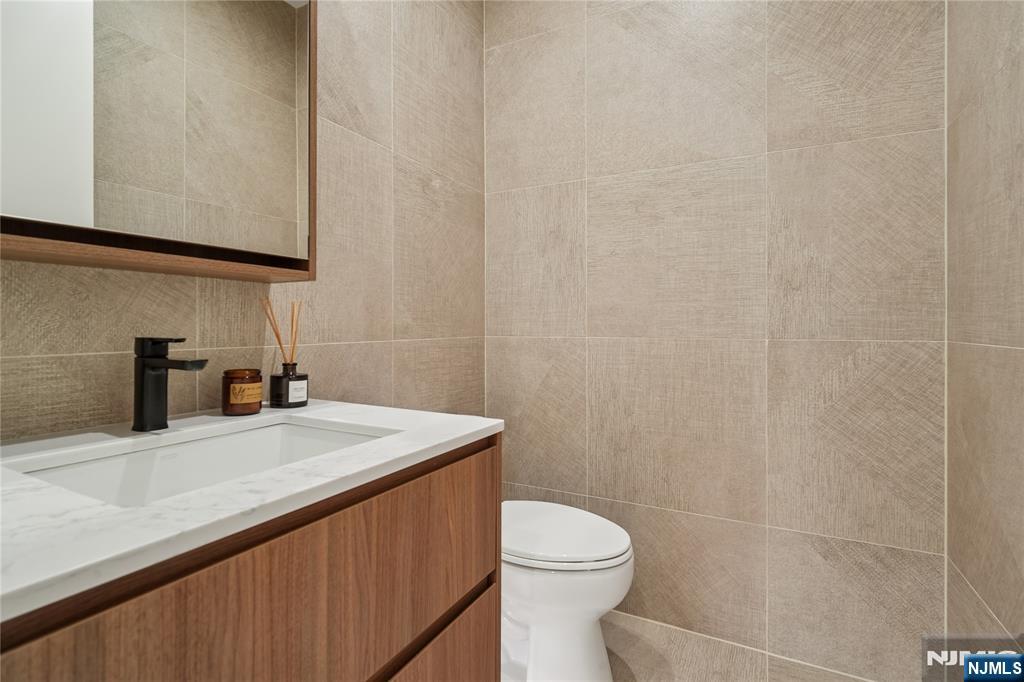 426 Aurora Avenue Cliffside Park, NJ 07010 - Photo 24 of 38 a bathroom with a sink a toilet and mirror