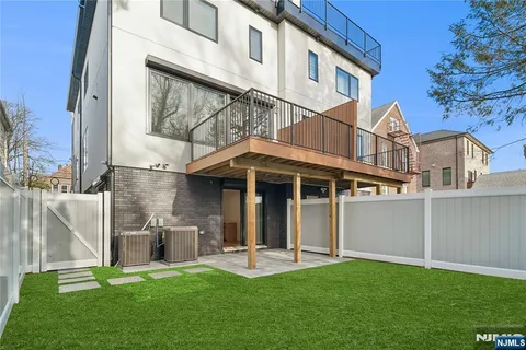 a front view of a house with a garden and plants