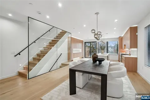 a dining room with furniture a chandelier and wooden floor