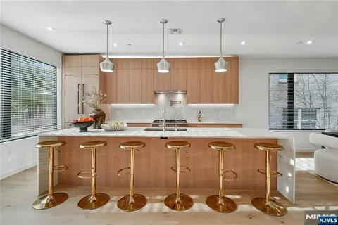 a kitchen with a table chairs stove and wooden floor