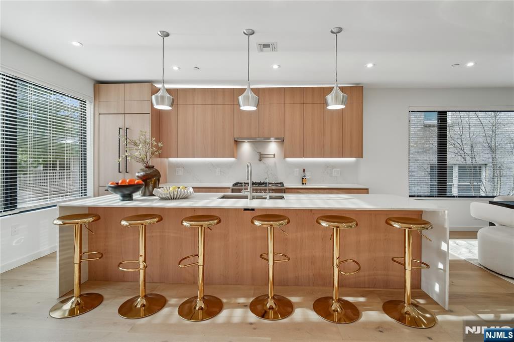426 Aurora Avenue Cliffside Park, NJ 07010 - Photo 5 of 38 a kitchen with a table chairs stove and wooden floor