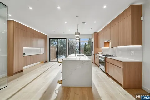 a large kitchen with kitchen island a large counter top space a sink and stainless steel appliances