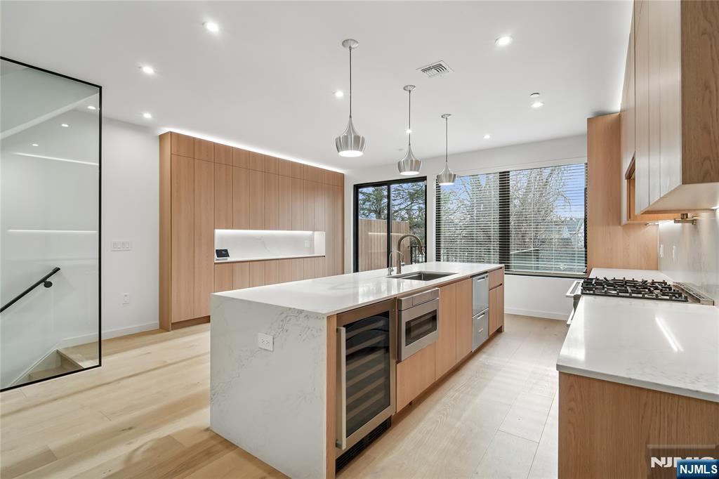 426 Aurora Avenue Cliffside Park, NJ 07010 - Photo 8 of 38 a large kitchen with kitchen island a large island a sink stainless steel appliances and cabinets