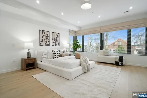 a spacious bedroom with a large bed and a large window