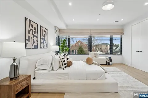 a large bedroom with a large bed and a large window