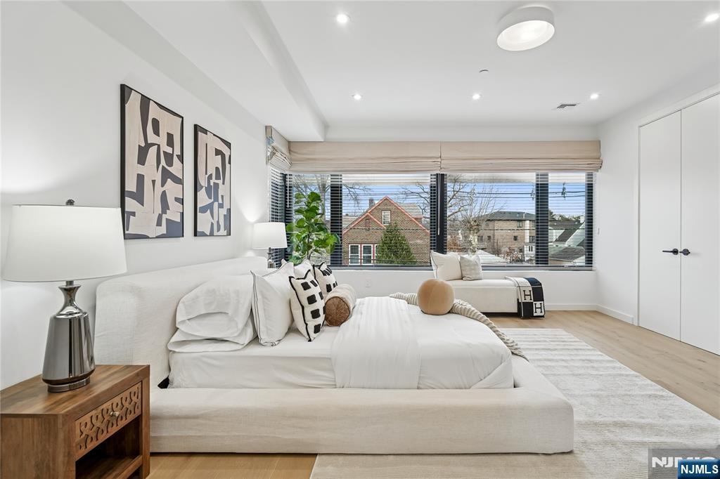 426 Aurora Avenue Cliffside Park, NJ 07010 - Photo 10 of 38 a large bedroom with a large bed and a large window