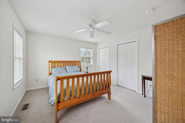 a bedroom with a bed lamp and a window