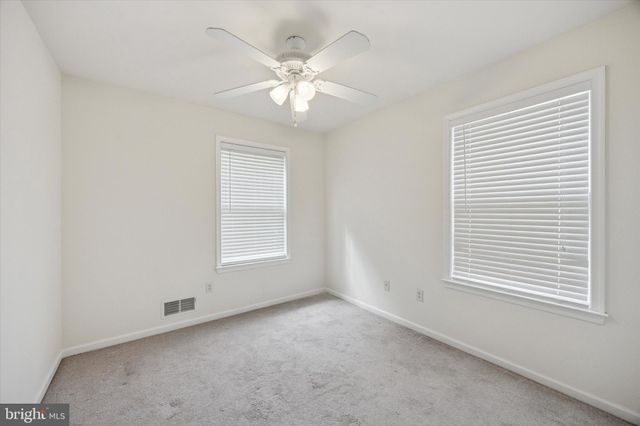 a bathroom with a granite countertop sink a toilet and a mirror