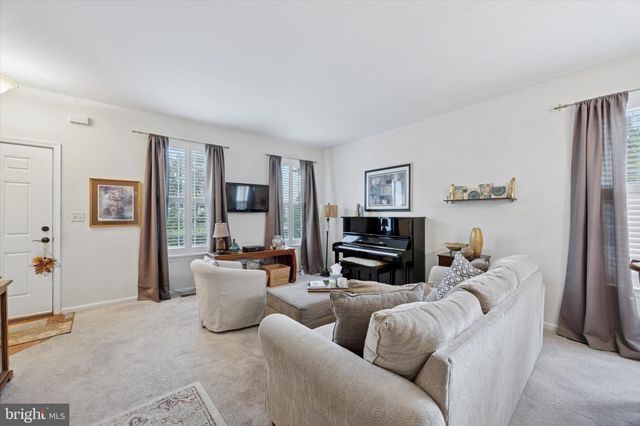 a living room with furniture and a piano