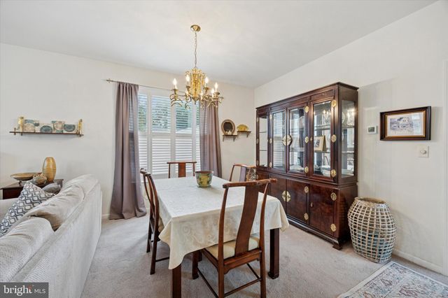 a view of a dining room with furniture and window