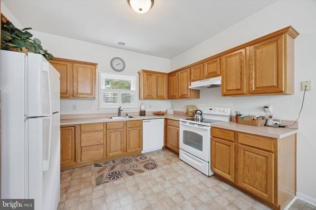 a living room with furniture a chandelier and a dining table