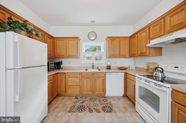 a kitchen with a white cabinets and white appliances