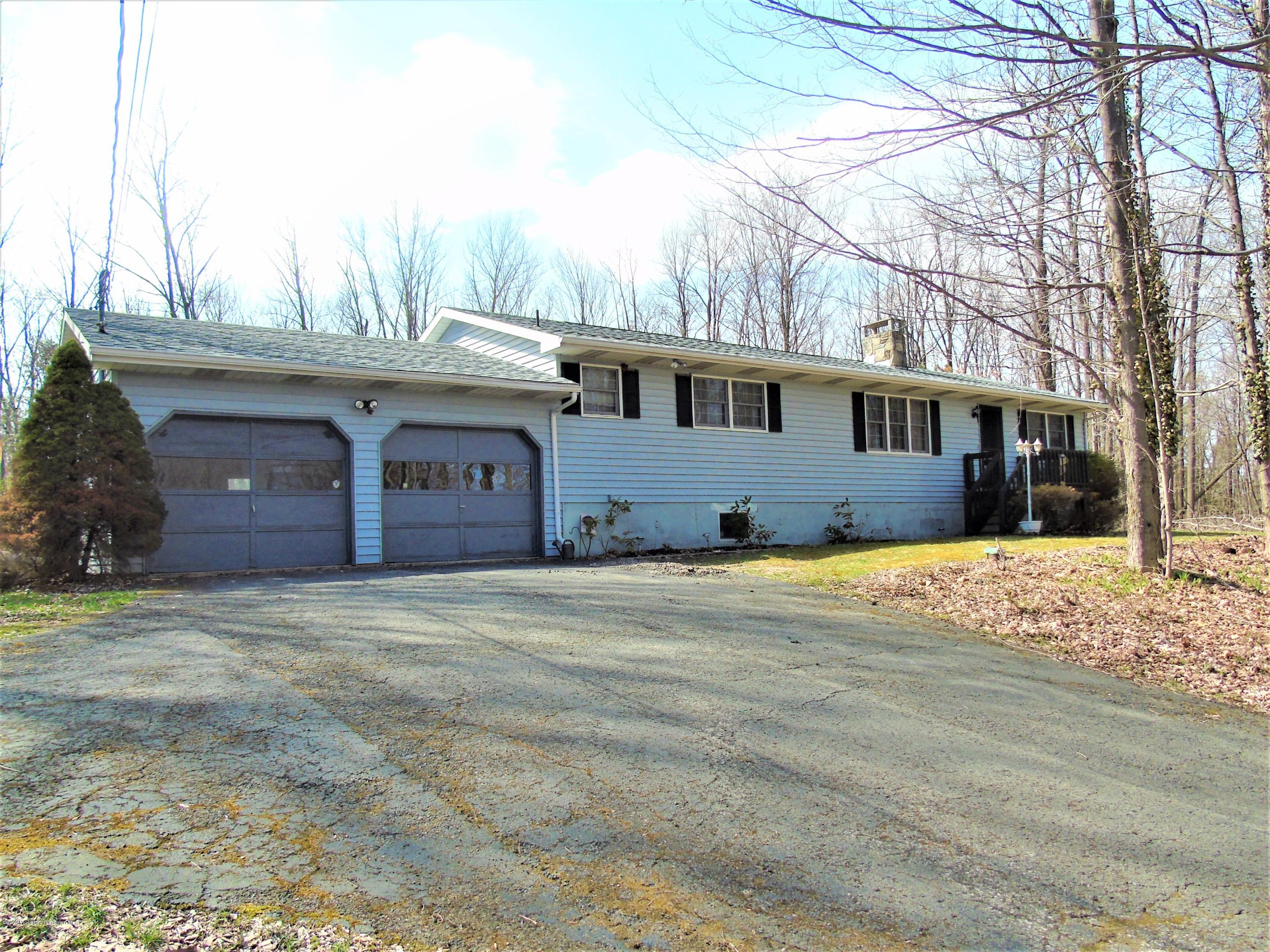 123 Anderson Road Lake Ariel, PA 18436 - Photo 1 of 37 a front view of a house with a yard and garage