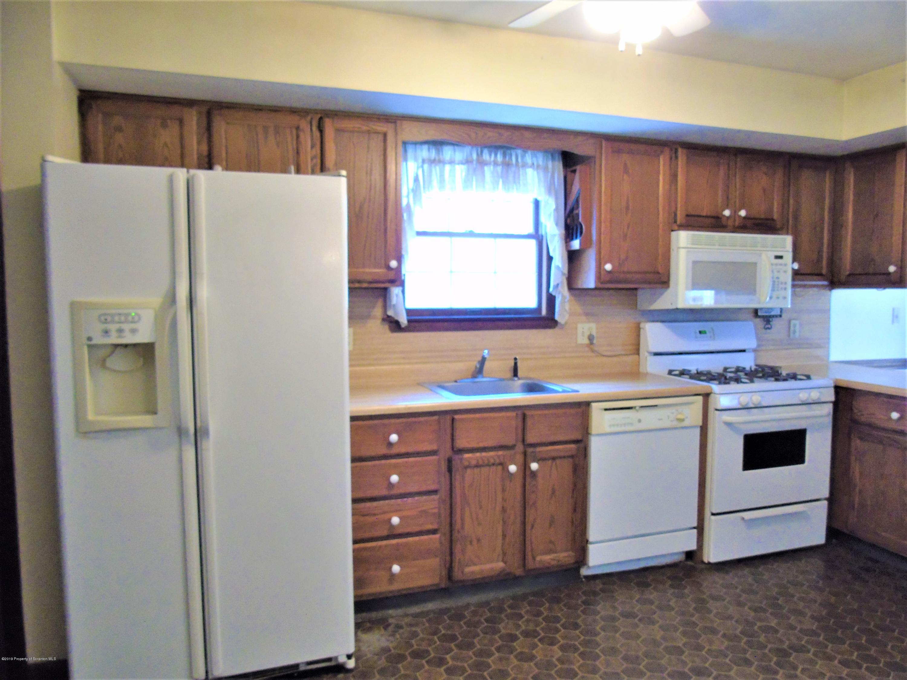 123 Anderson Road Lake Ariel, PA 18436 - Photo 3 of 37 a kitchen with stainless steel appliances a refrigerator sink and cabinets