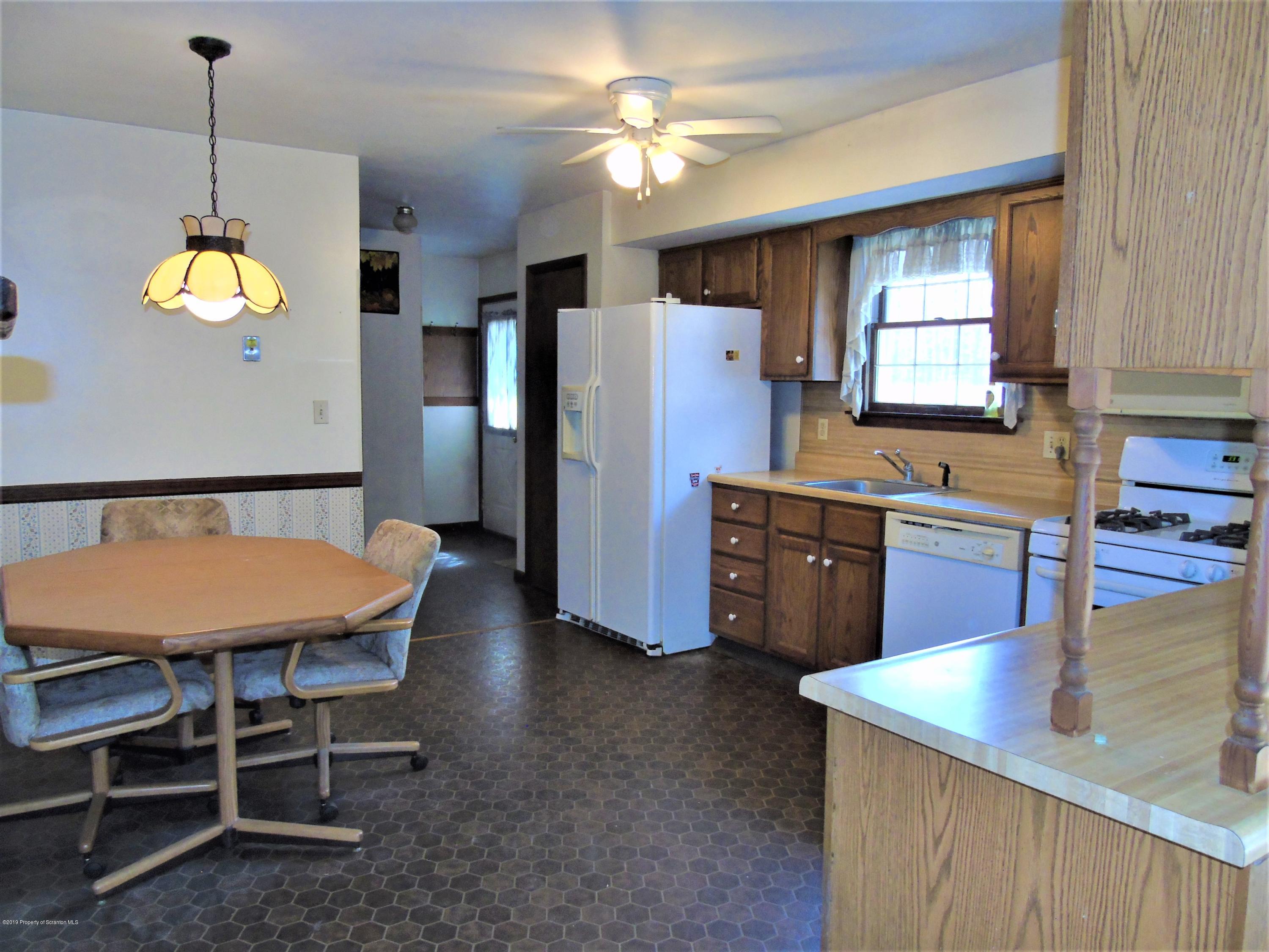 123 Anderson Road Lake Ariel, PA 18436 - Photo 5 of 37 a kitchen with stainless steel appliances granite countertop a sink a stove a refrigerator a center island a dining table and chairs