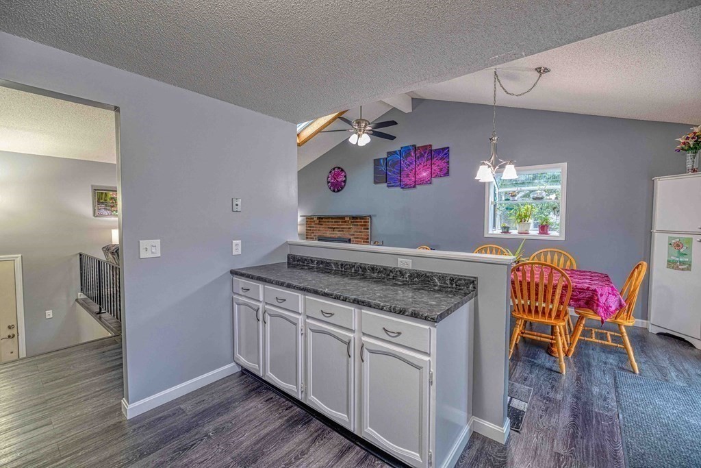 583 Wood Street Fall River, MA 02721 - Photo 11 of 32 a kitchen with stainless steel appliances granite countertop a kitchen island hardwood floor and a sink