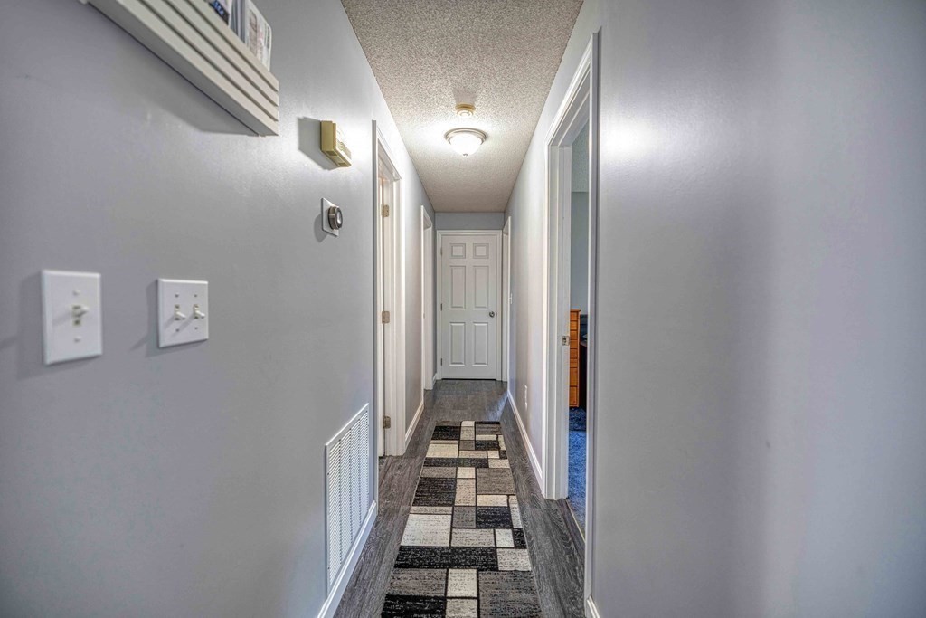583 Wood Street Fall River, MA 02721 - Photo 14 of 32 a view of a hallway with wooden floor and a bathroom
