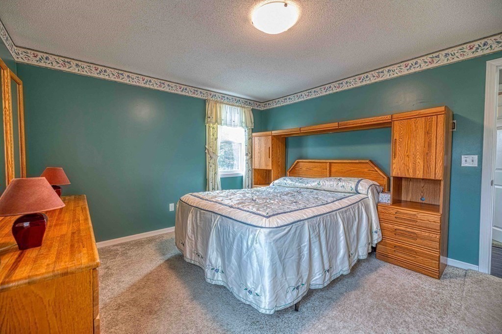 583 Wood Street Fall River, MA 02721 - Photo 17 of 32 a bedroom with a bed and a window