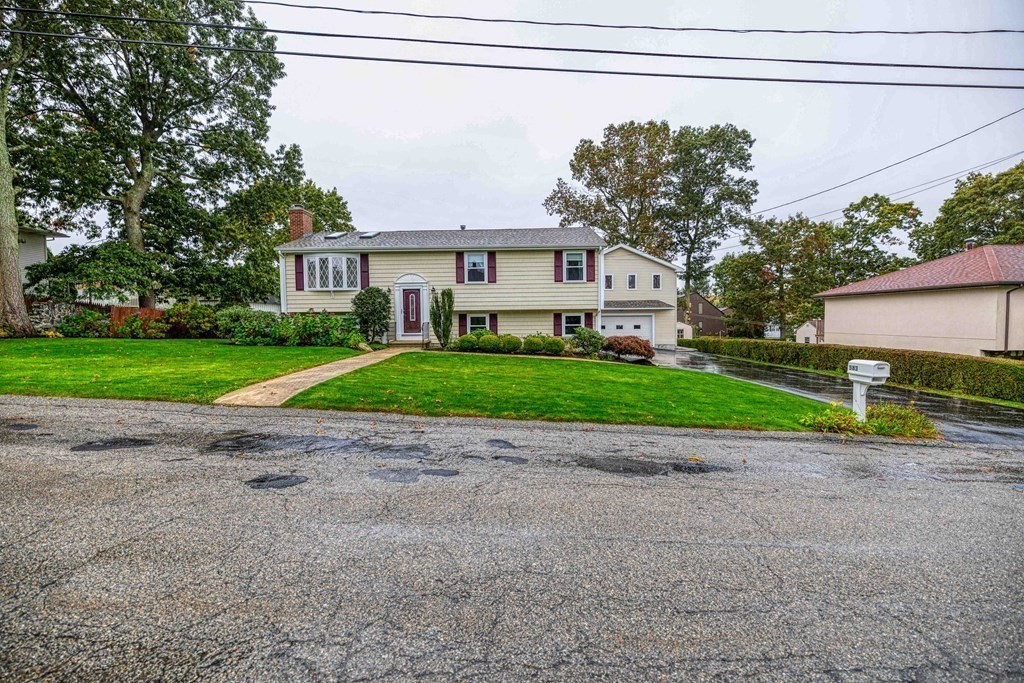 583 Wood Street Fall River, MA 02721 - Photo 3 of 32 a view of a house with a yard and large tree