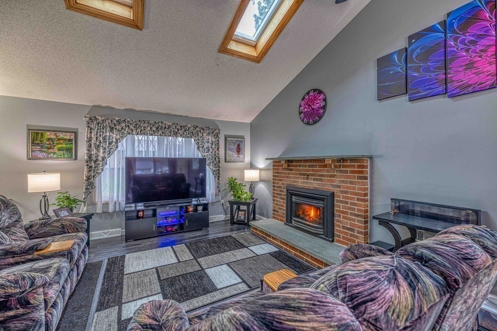 583 Wood Street Fall River, MA 02721 - Photo 8 of 32 a living room with furniture and a fireplace