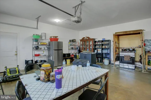a room with furniture and view of kitchen
