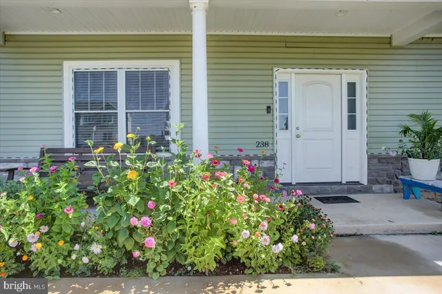 a flower garden is sitting in front of a house