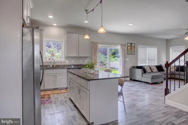 a kitchen with stainless steel appliances granite countertop a stove and a refrigerator