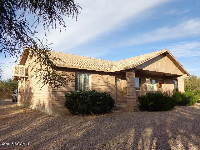 362 Camino Ramanote Rio Rico, AZ 85648 - Photo 2 of 12 a front view of a house with a garden