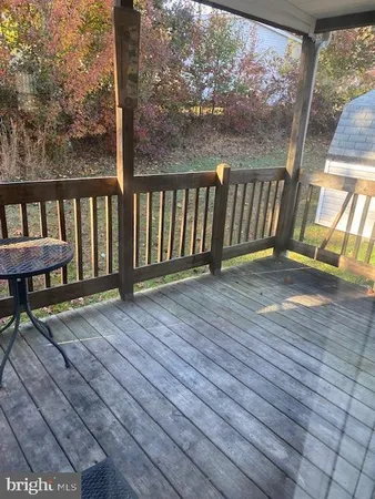 a view of wooden floor with a bench