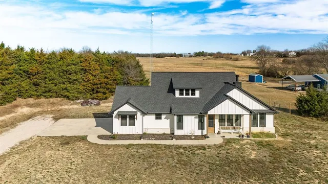 an aerial view of a house with a yard