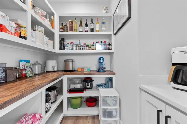 a utility room with lots of clutter and washer