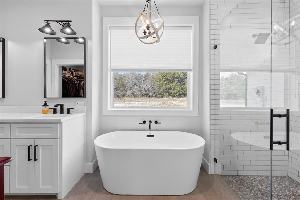 4700 County Road 1040 Celeste, TX 75423 - Photo 18 of 40 a white bath tub sitting next to a bathroom sink