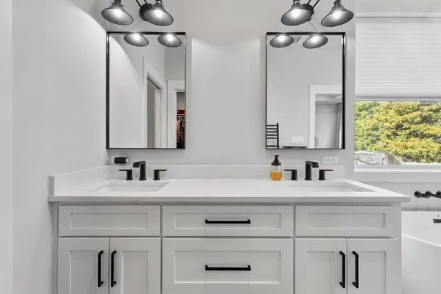 a bathroom with a sink vanity and a mirror