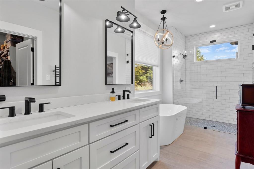 4700 County Road 1040 Celeste, TX 75423 - Photo 21 of 40 a bathroom with a double vanity sink mirror and bathtub