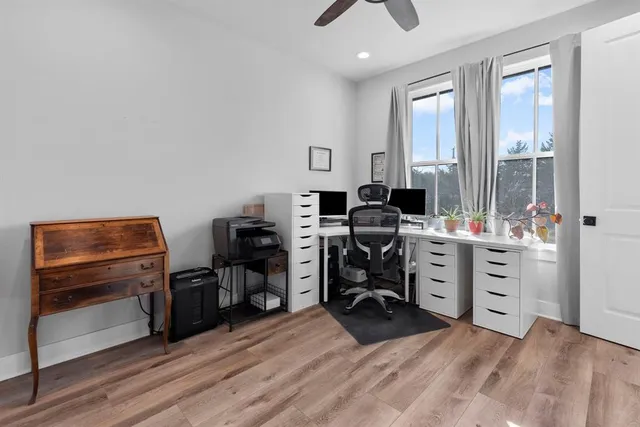 a view of a workspace with furniture and a window