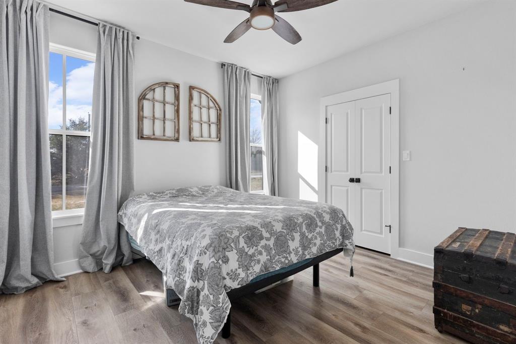 4700 County Road 1040 Celeste, TX 75423 - Photo 26 of 40 a bedroom with a bed and a chandelier