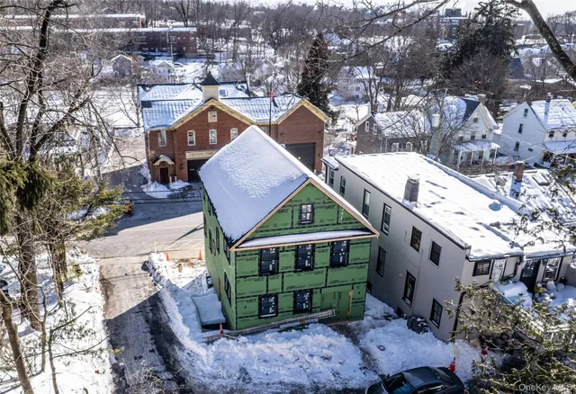 a aerial view of a house with a yard