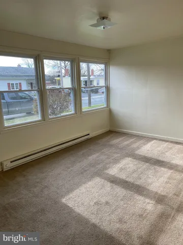 an empty room with a empty space and windows