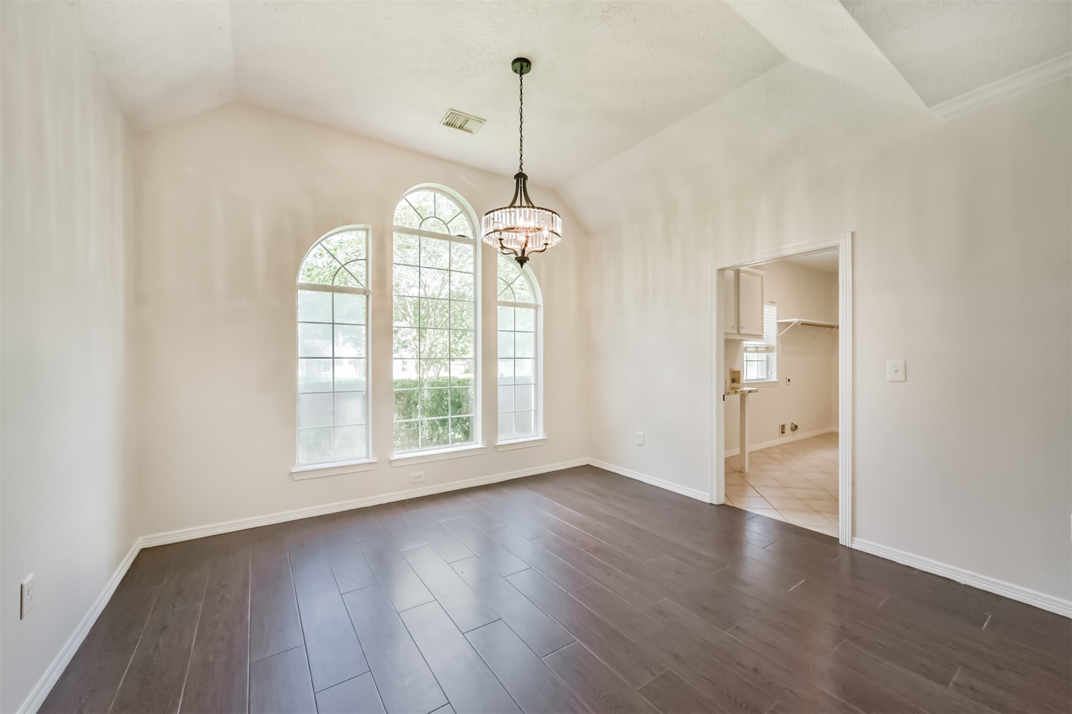27322 Afton Way Huffman, TX 77336 - Photo 32 of 50 Elegant formal dining room features soaring ceilings, dramatic arched windows, and designer lighting for memorable gatherings.