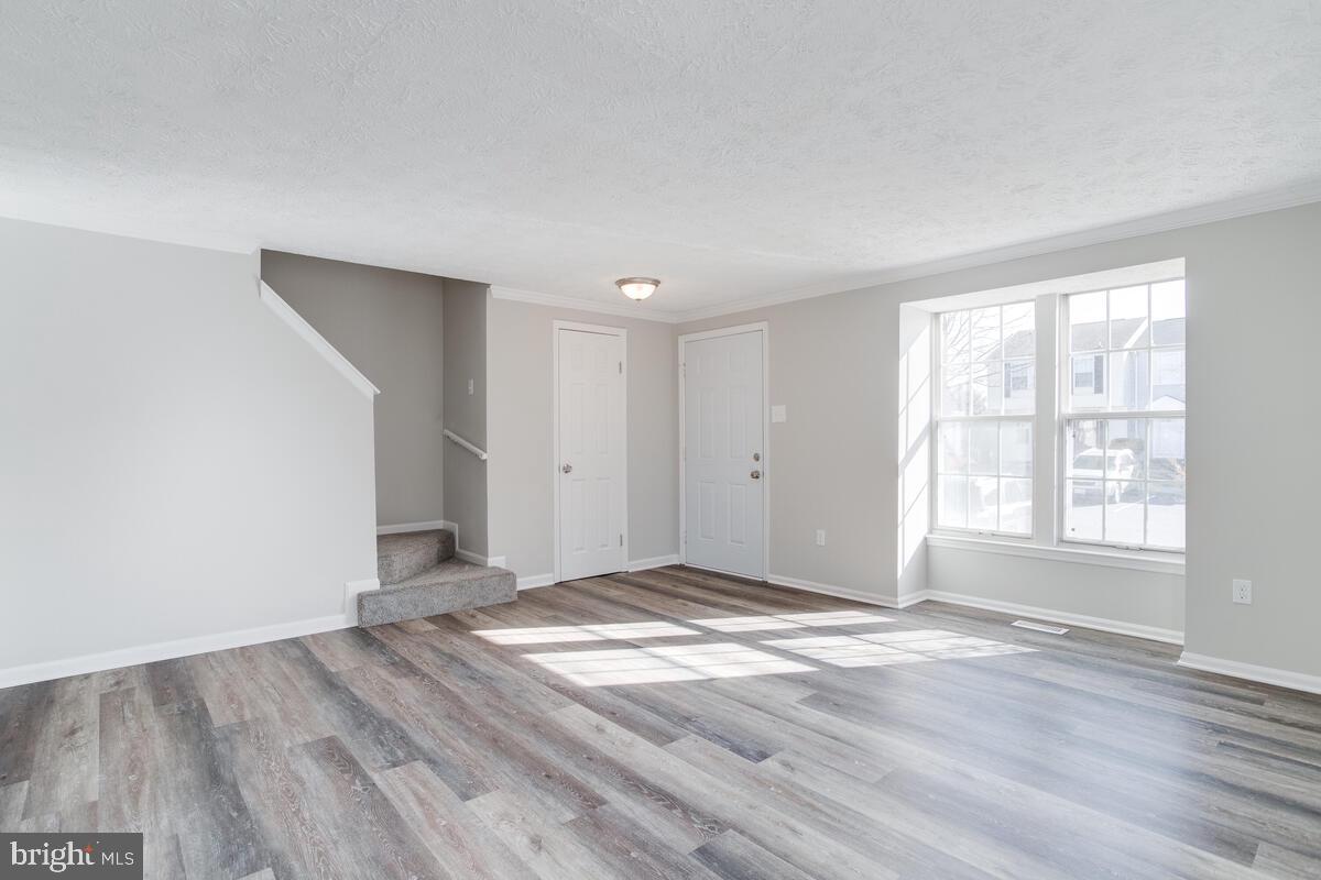 1308 Apple Ridge Court Edgewood, MD 21040 - Photo 7 of 38 an empty room with wooden floor and windows
