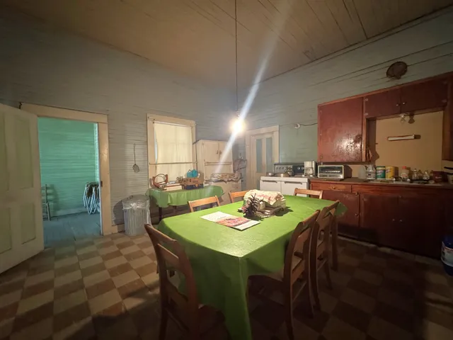 a view of a dining room with furniture and a chandelier