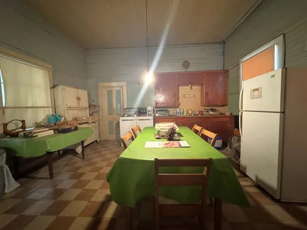 a view of kitchen with furniture and a refrigerator