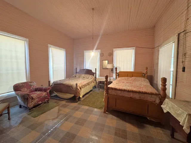 a spacious bedroom with a bed and window