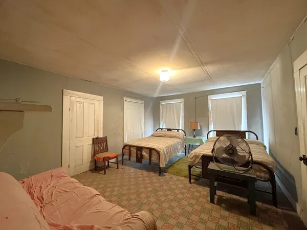 a bedroom with two beds and a window