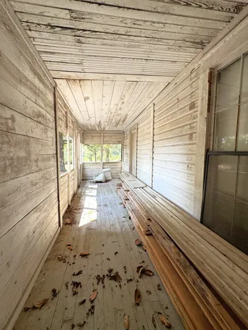 a view of a porch with wooden floor