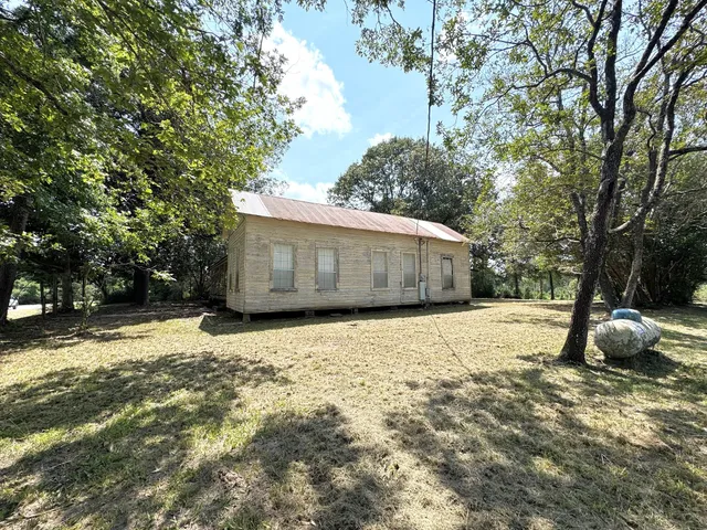a house with trees in the background