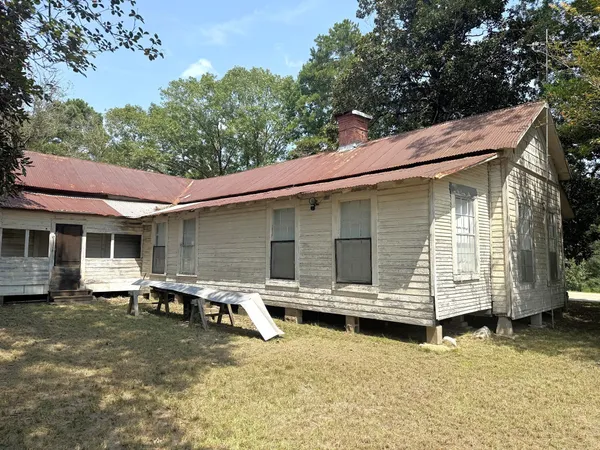 a view of a house with backyard tub and wooden fence