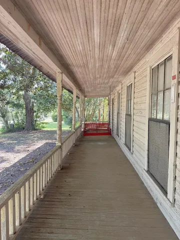 a view of a porch with wooden floor and outdoor space